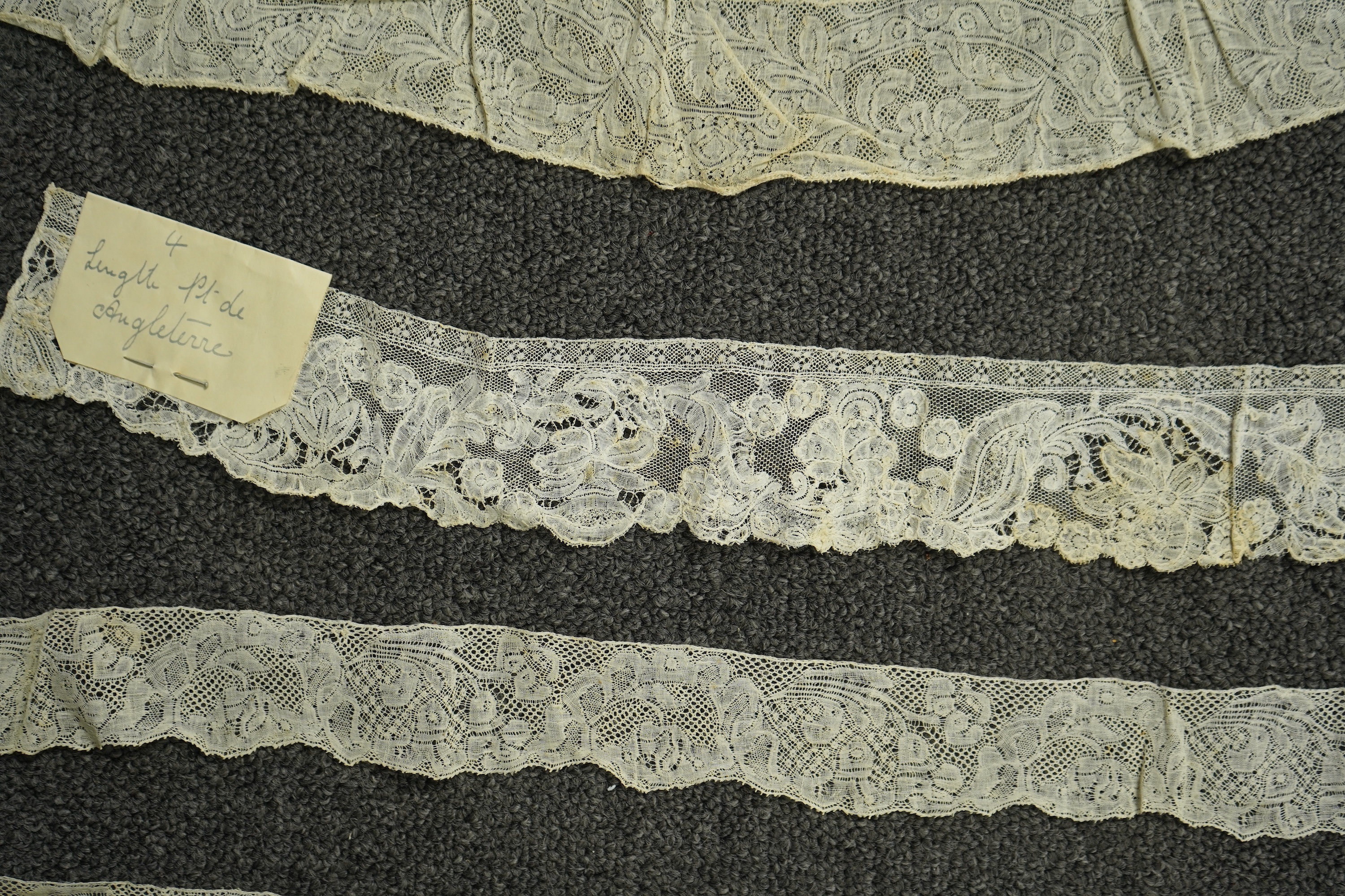 Various lengths of 18th and 19th century lace trimming and two needle run bonnets. Including a collar made from two rows of 18th century Valenciennes lace, a length Valenciennes lace, a shorter length of Pointe de Anglet